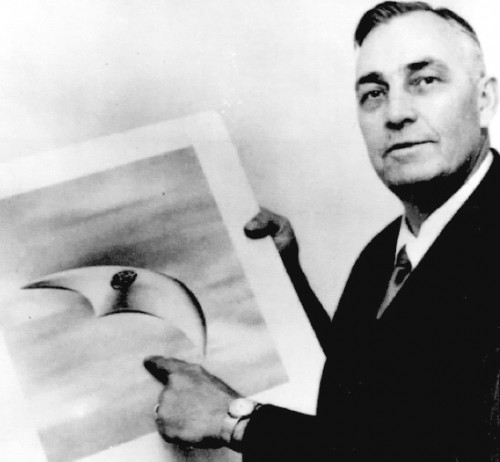 Kenneth Arnold holding an artist's rendering of the UFOs he saw in 1947