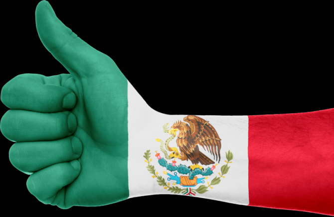 Hand with thumbs up painted with Mexican flag
