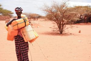 A man carrying water cans in Qarqora, Galmudug, Somalia